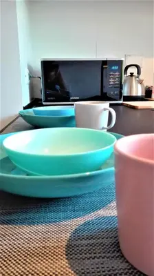 a table with two plates and a laptop on a counter at VATICAN APARTMENT MELORIA in Rome