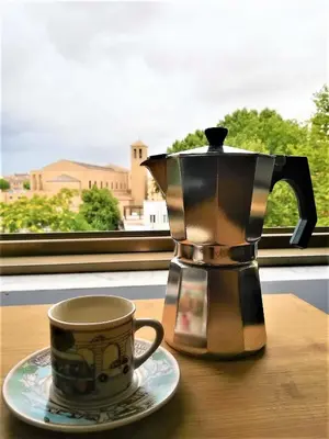 a coffee pot and a cup on a table at VATICAN APARTMENT MELORIA in Rome