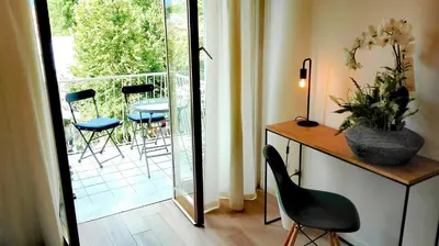 a room with a desk and a chair and a balcony at VATICAN APARTMENT MELORIA in Rome