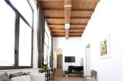 a living room with a couch and some windows at Luxury House Colosseo in Rome