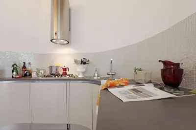 a kitchen with a sink and a counter top at Luxury House Colosseo in Rome