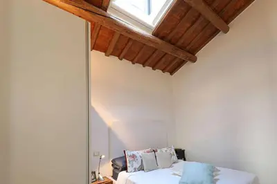 a bedroom with a bed in a room with a window at Luxury House Colosseo in Rome