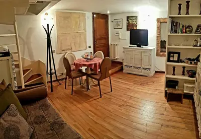 a living room with a table and a television at Navona Best House in Rome