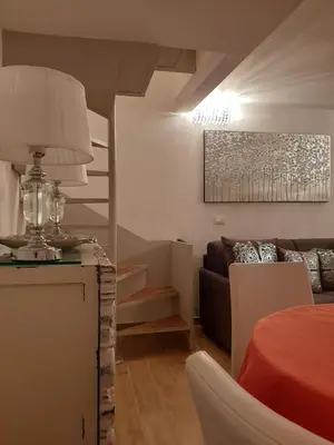 a living room with a couch and a table with a lamp at Navona Best House in Rome