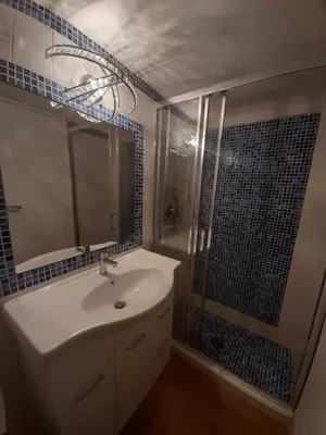 a bathroom with a sink and a shower with a mirror at Navona Best House in Rome