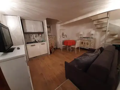 a living room with a couch and a kitchen at Navona Best House in Rome