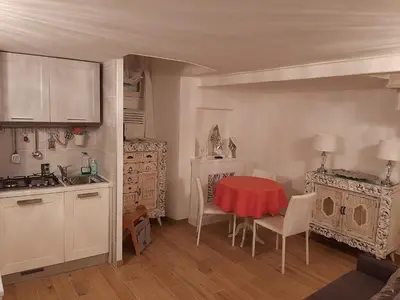 a kitchen with a red table and chairs in a room at Navona Best House in Rome