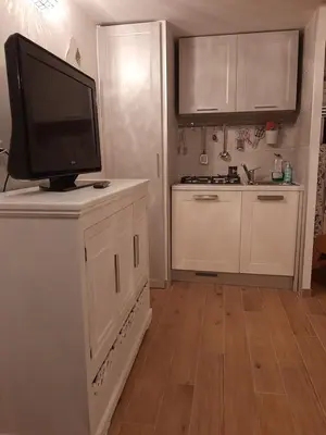 a kitchen with a flat screen tv on top of a counter at Navona Best House in Rome