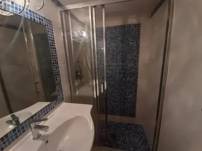 a bathroom with a sink and a glass shower at Navona Best House in Rome