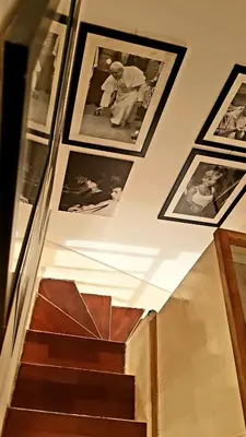 a stairway with pictures on the wall and a stair case at Navona Best House in Rome