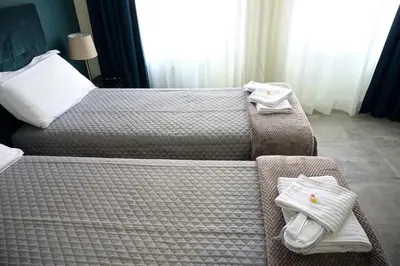 a bedroom with a bed with white towels on it at Regolo Rooms Vaticano in Rome