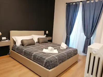 a bedroom with a bed with two towels on it at Chroma Italy - Doctor House in Rome