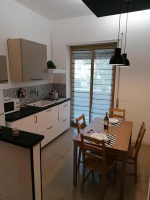 a kitchen with a table and chairs and a dining room at Chroma Italy - Doctor House in Rome
