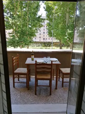 a table and chairs on a patio with a window at Chroma Italy - Doctor House in Rome