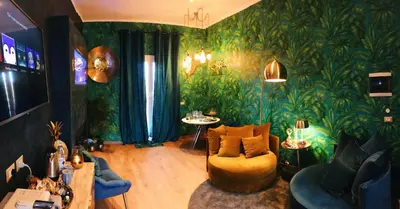 a living room with green plants on the walls at Rooftop Colosseo - Roma d'Amore in Rome