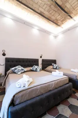 two beds in a room with towels on them at Museum Inn - Una finestra sui Musei Vaticani in Rome