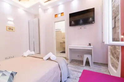 a bedroom with a bed and a tv on the wall at Museum Inn - Una finestra sui Musei Vaticani in Rome