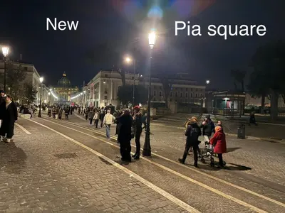 a group of people walking down a street at night at Museum Inn - Una finestra sui Musei Vaticani in Rome