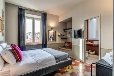 a hotel room with a bed and a television at CORNER211 in Rome