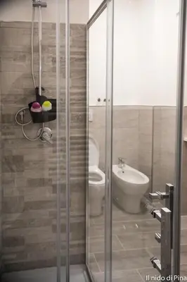 a bathroom with a shower and a toilet and a sink at Nido di Pina in Rome