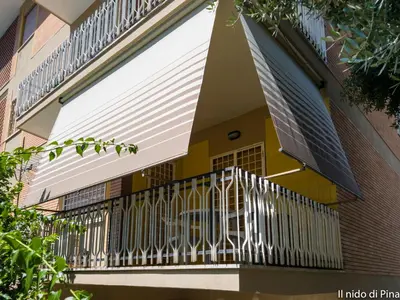 a balcony of a building with a white railing at Nido di Pina in Rome