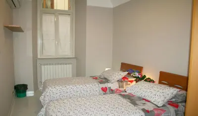 a bedroom with two beds and a window at Montebello - Julia Apartment in Rome