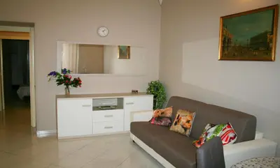 a living room with a couch and a mirror at Montebello - Julia Apartment in Rome