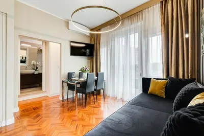 a living room with a couch and a dining room at Frattina High-end apt in Rome
