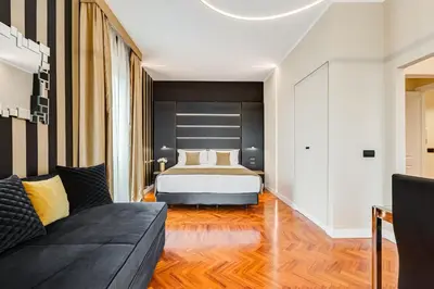 a bedroom with a bed and a couch at Frattina High-end apt in Rome