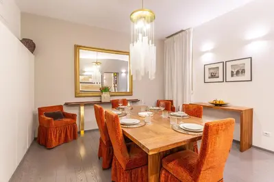 a dining room with a wooden table and chairs at Spanish Steps DeLuxe Apartment in Rome
