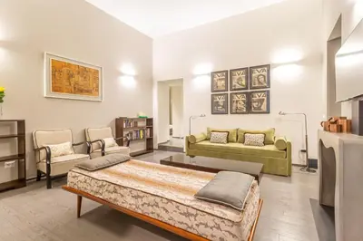 a living room with a bed and a couch at Spanish Steps DeLuxe Apartment in Rome