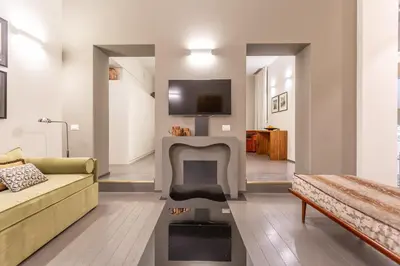 a living room with a couch and a fireplace at Spanish Steps DeLuxe Apartment in Rome