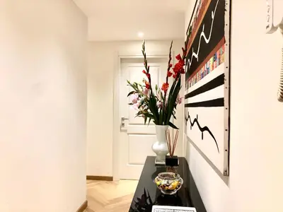 a vase of flowers on a table in a room at Opera Luxury Rosmini in Rome