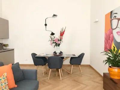 a living room with a table with a vase of flowers on it at Opera Luxury Rosmini in Rome
