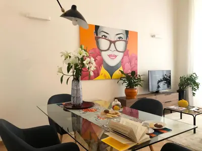a dining room with a glass table and a painting at Opera Luxury Rosmini in Rome