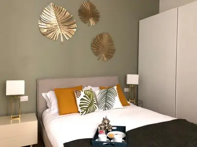 a bedroom with a bed and two mirrors on the wall at Opera Luxury Rosmini in Rome
