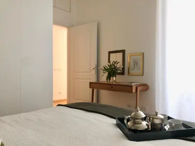 a bedroom with a bed with a table and a desk at Opera Luxury Rosmini in Rome
