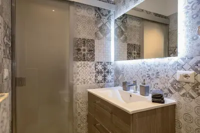 a bathroom with a sink and a shower at La Finestra su Fontana di Trevi - Charming View in Rome