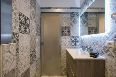 a bathroom with a sink and a shower at La Finestra su Fontana di Trevi - Charming View in Rome