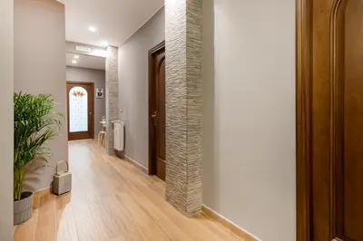 a hallway with a brick pillar in a building at B&B Il Dogandiere in Rome