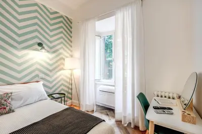 a bedroom with a bed and a desk and a window at Trastevere 2.0 in Rome