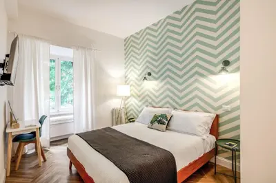 a bedroom with a bed and a striped wall at Trastevere 2.0 in Rome