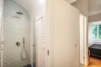 a bathroom with a walk in shower next to a window at Trastevere 2.0 in Rome