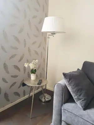 a living room with a couch and a table with a lamp at Clementinam Suite Colosseum in Rome