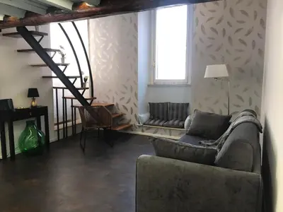 a living room with a couch and a chair at Clementinam Suite Colosseum in Rome