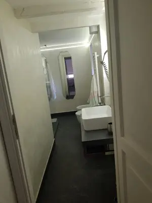 a bathroom with a sink and two toilets and a mirror at Clementinam Suite Colosseum in Rome