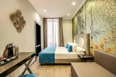 a hotel room with a bed and a couch at Relais De La Poste in Rome