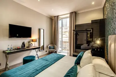a hotel room with a bed and a tv at Relais De La Poste in Rome