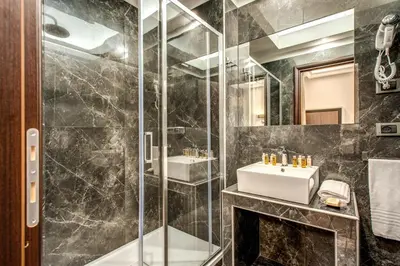 a bathroom with a sink and a shower at Relais De La Poste in Rome