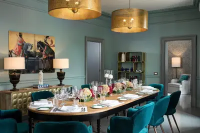 a dining room with a long table and chairs at Rocco Forte House Piazza Di Spagna, Rome in Rome